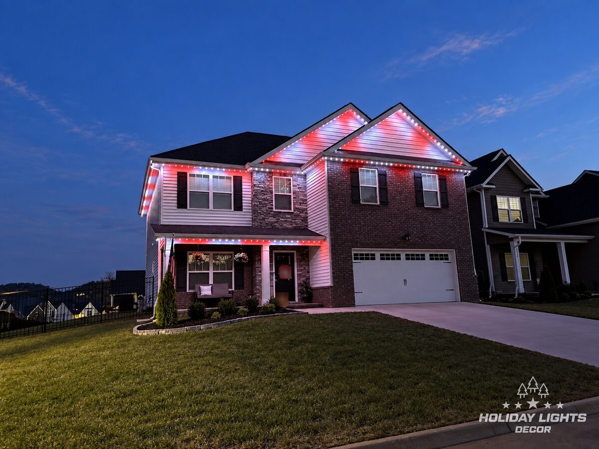 Two-story home in Atlantic Highlands with red-and-white permanent roofline lights